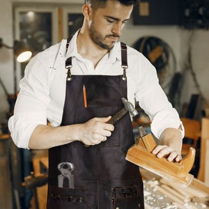 Waxed brown full-grain leather cross-back apron with front utility pockets